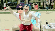a man and a child are posing for a picture on a beach ..