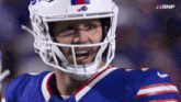 a close up of a football player wearing a helmet with snf written on the bottom