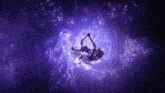 a man and woman are dancing in a dark room with purple lights .
