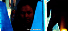 a woman in a dark room says " eat shit shit-eaters ! "
