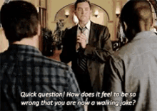 a man in a suit and tie is talking to another man in a plaid shirt