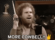 a man with a beard holds a drum stick and says " more cowbell "