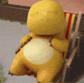 a yellow cartoon character is sitting in a chair with his eyes closed