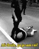 a black and white photo of a man laying on the ground with the words ali druge pa ja sam vas