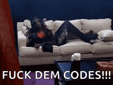 a woman is laying on a couch with the words " fuck dem codes " written on the bottom .