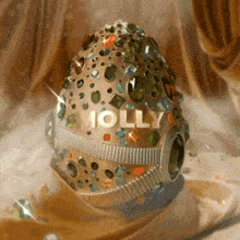 molly is written on a jeweled egg on a table