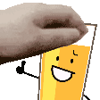 a hand is holding a glass of orange juice with a smiley face on it .