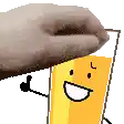 a hand is holding a glass of orange juice with a smiley face on it .