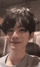 a close up of a person 's face with short black hair