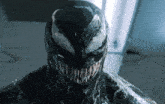 a close up of venom 's face with a huge smile