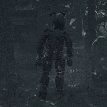 a black bunny rabbit is standing in the woods in a video game .