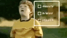 a boy in a yellow shirt is standing in front of a sign that says muscle brains stealth .