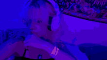 a blurry picture of two people dancing in a dark room with purple lights .