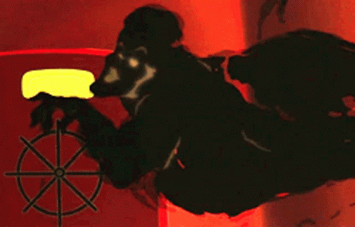 GIF, Animation, film clip. From Ferngully, Hexxus who is an anthropomorphized cloud of toxic smoke, spins a wheel door latch to open a port door for a sealed red chamber, enters and closes the door behind himself while singing "Toxic Love".
