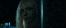 a close up of a woman 's face in a dark room .