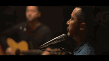 a close up of a person playing an acoustic guitar with a yamaha logo on the neck