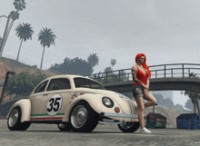 a woman stands in front of a herbie beetle with the number 35 on it