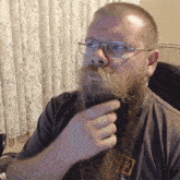 a man with a beard wearing glasses and a shirt that says f2 on it