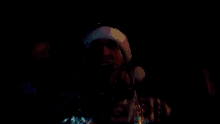 a man wearing a santa hat and headphones is dancing