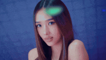 a woman with long hair looks at the camera
