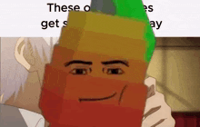 a gummy bear with a face drawn on it is being held by a man .