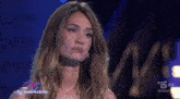 a woman appears on a television show with the hashtag #grandefratello