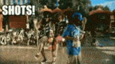 a group of people are dancing in front of a pool and the word shots is on the bottom