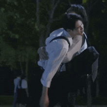 a man is carrying another man on his shoulders .