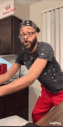 a man wearing glasses and a bandana with the name betty boop on the bottom