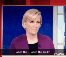 a woman in a purple jacket says what the hell