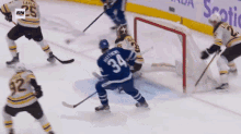 a hockey player with the number 34 on his jersey stands in front of a goal