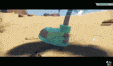 a screenshot of a video game with a shadow of a person in the sand