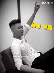 a man sitting in a chair with his hand up and the words no no on the bottom