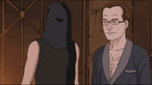 a man with glasses stands next to a man with a black hood