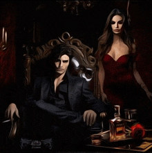 a man in a black suit sits in a chair next to a woman in a red dress and a bottle of jack daniels
