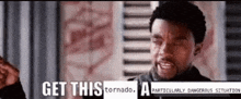 a man is standing in front of a window with the words `` get this tornado a particularly dangerous situation ''