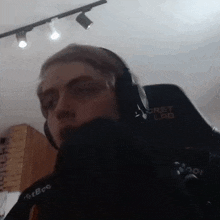 a man wearing headphones is sitting in a chair in a room .
