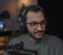a man wearing glasses and headphones is looking at the camera
