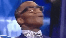 a man in a suit and tie is making a funny face and saying `` no deal '' .