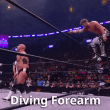 a wrestler is doing a diving forearm on another wrestler in the ring .