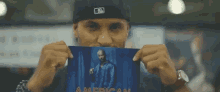 a man is holding a picture of snoop dogg