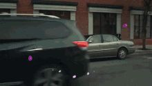 a man in a suit and tie is standing next to a car