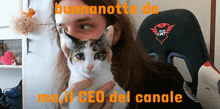 a man holding a cat with the words buonanotte da me il ceo del canale written on it