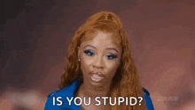 a woman with red hair is making a funny face and asking is you stupid .