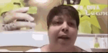 a woman is talking on a video call while holding a cell phone in her hand .