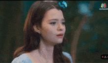 a woman in a blue dress is crying with a tear coming out of her eye