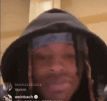 a man with dreadlocks is wearing a hoodie and a bandana on his head ..