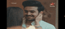 a man and a woman are looking at each other with a star plus logo in the background