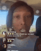a woman is sitting in the back seat of a car talking to someone .