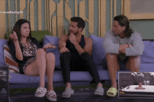 a group of people sitting on a couch in front of a tv screen that says universoreality tv